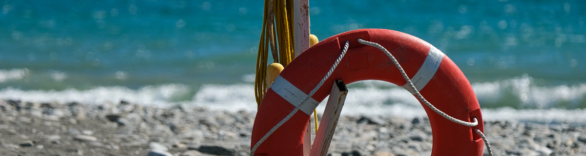 A life preserver on a dirty beach illustrates the need for something to hang onto in 2020.