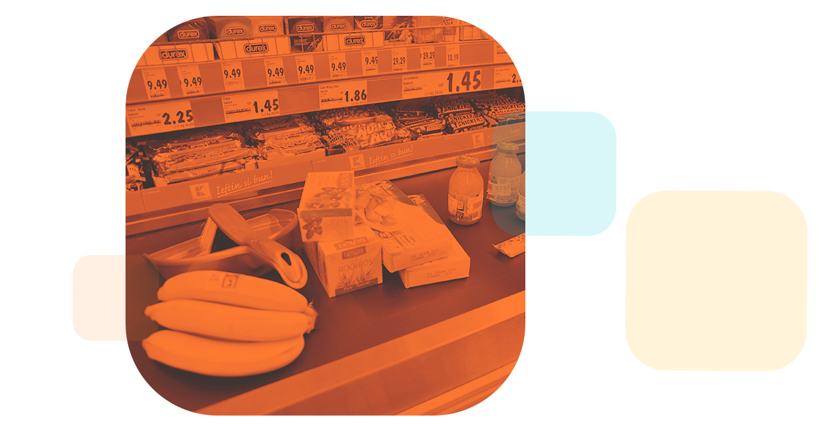 an orange grocery store conveyor belt brings a number of products to the barcode scanner
