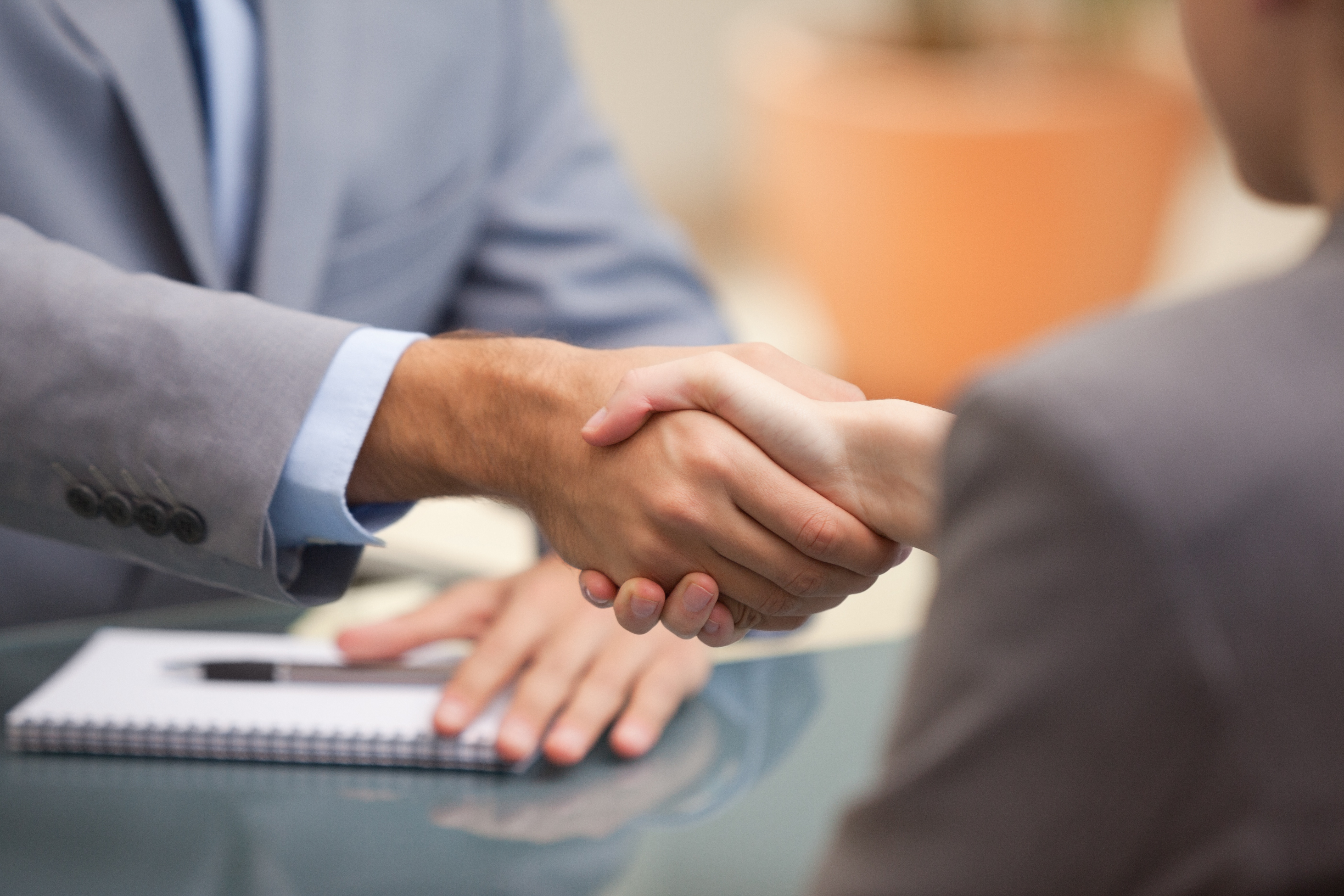 Stock Photo of a manager shaking hands with a new hire.