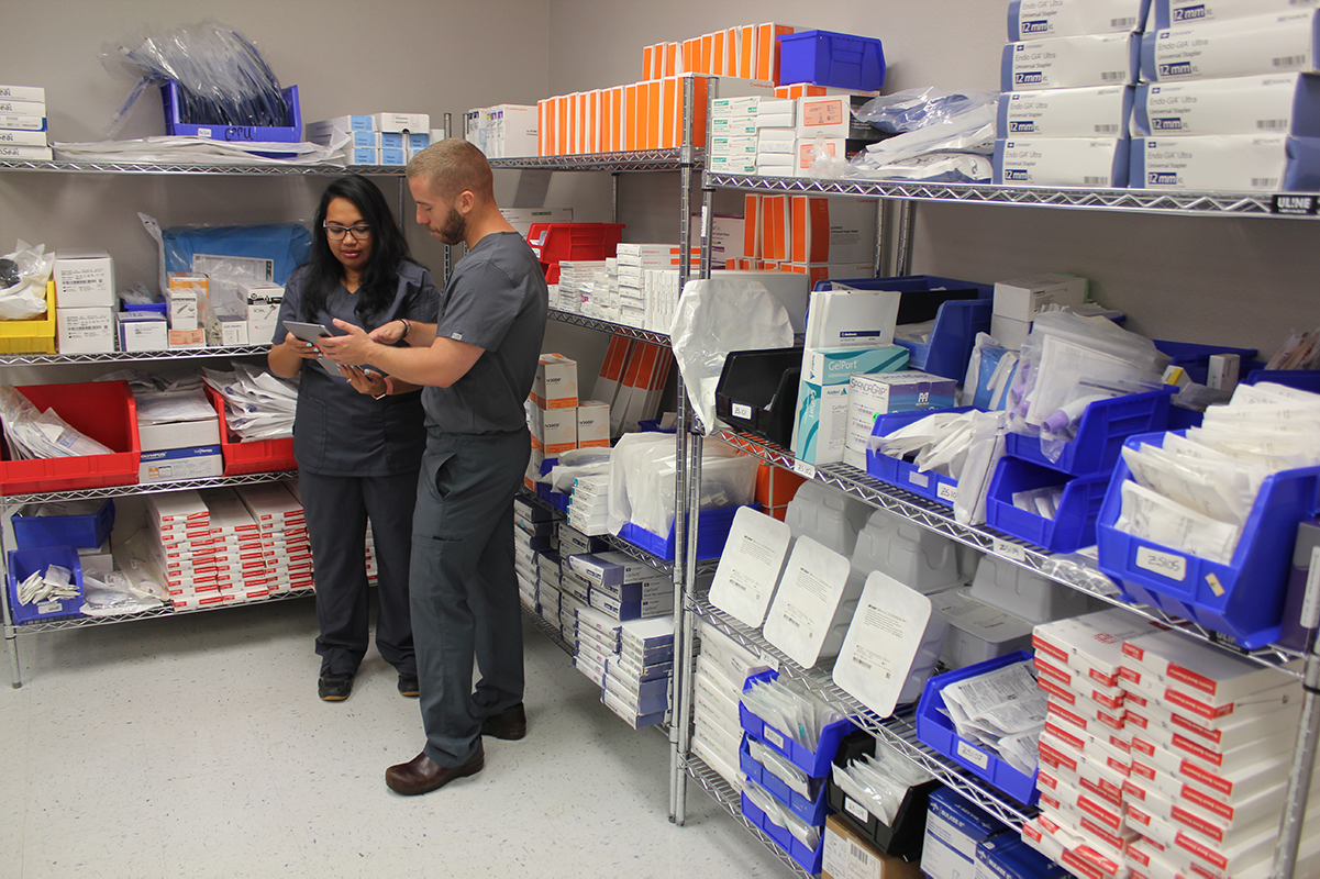 Two reallocation specialists use Z5 Inventory's mobile app to identify excess inventory.